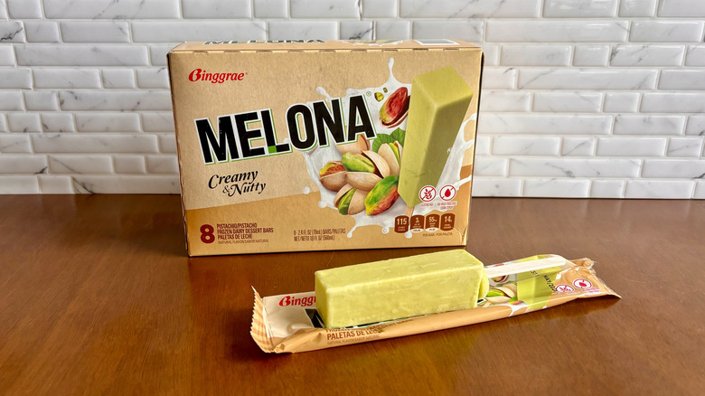 Melona pistachio ice cream bar box with Melona popsicle unwrapped