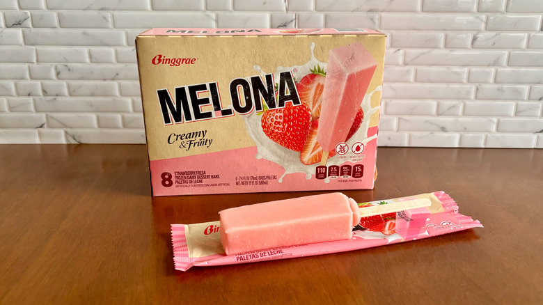 Melona strawberry ice cream bar box with Melona popsicle laid out