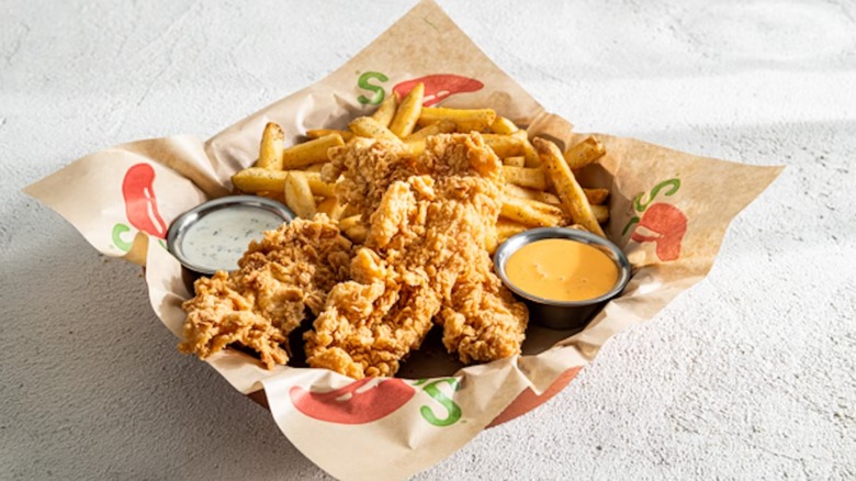 Chili's 3ct Crisper Combo with two bowls of different dressings and fries, nestled in paper with the Chili's logo