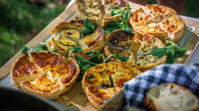 Multiple quiches on serving board