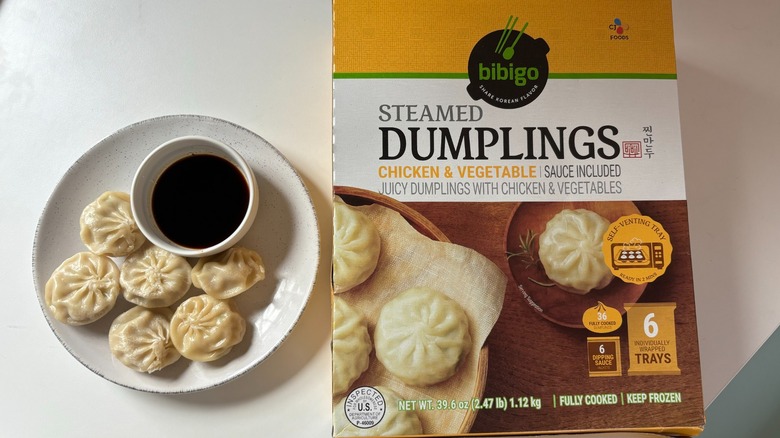 Bibigo steamed dumplings and box on table