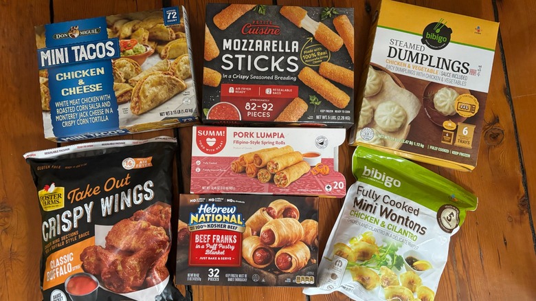 Seven Costco frozen appetizer packages laid out