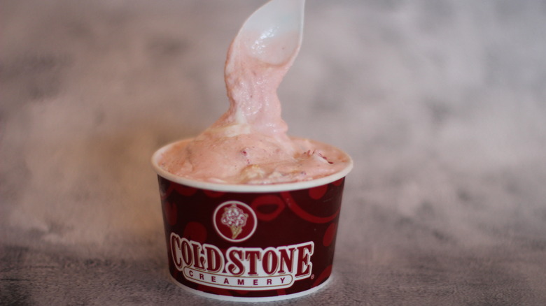 Strawberry ice cream with plastic spoon in a cold stone creamery cup