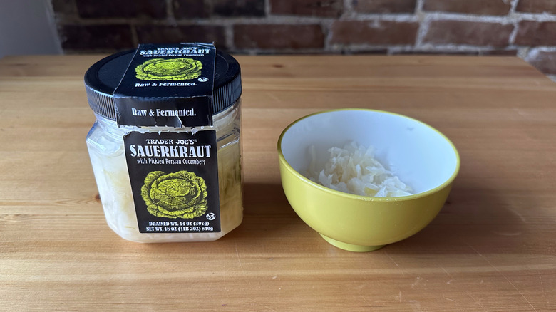 Trader Joe's Sauerkraut with Pickled Persian Cucumbers on wooden table and in bowl
