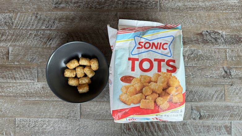 Sonic tots on table next to bowl of tots