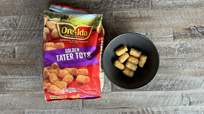 Ore-Ida tater tots on table next to bowl of tots