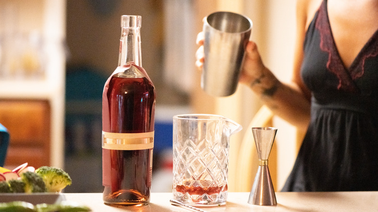 woman mixing cocktail at home