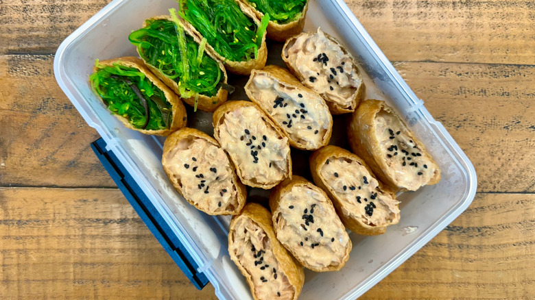 Inari sushi with sesame salad in plastic packaging