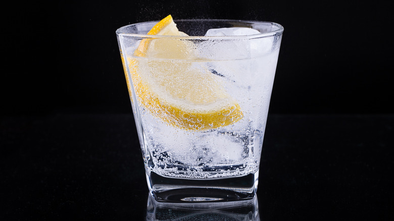 fizzing vodka drink with lemon wedge added