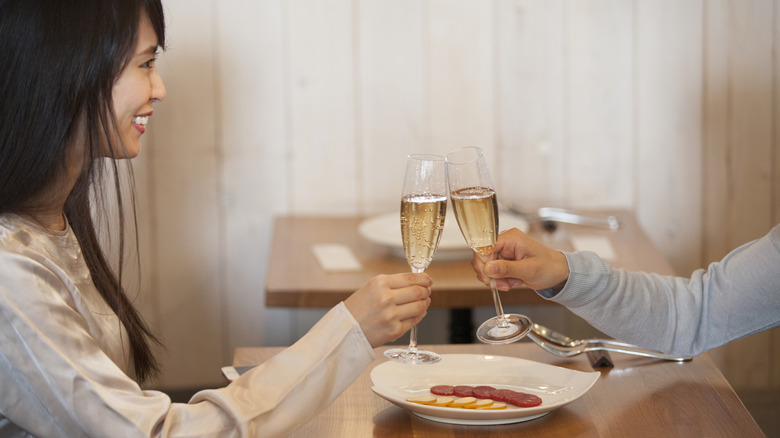 Diners clinking glasses of sparkling sake