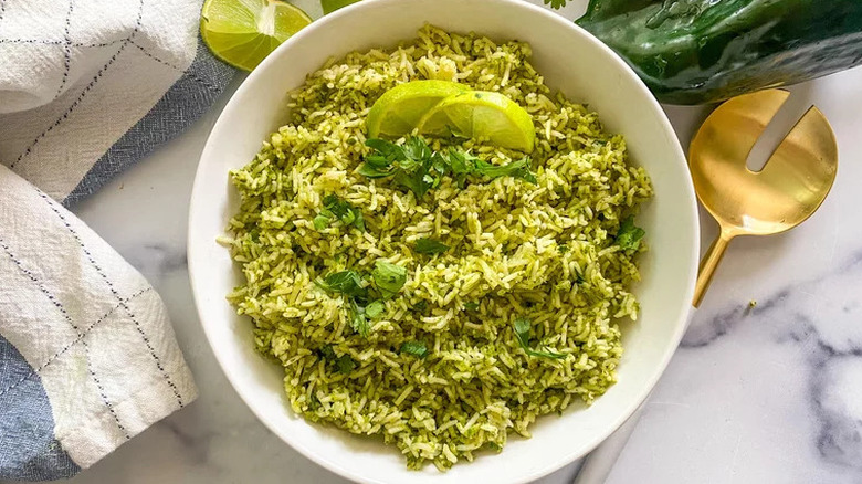 Green rice with lime wedges