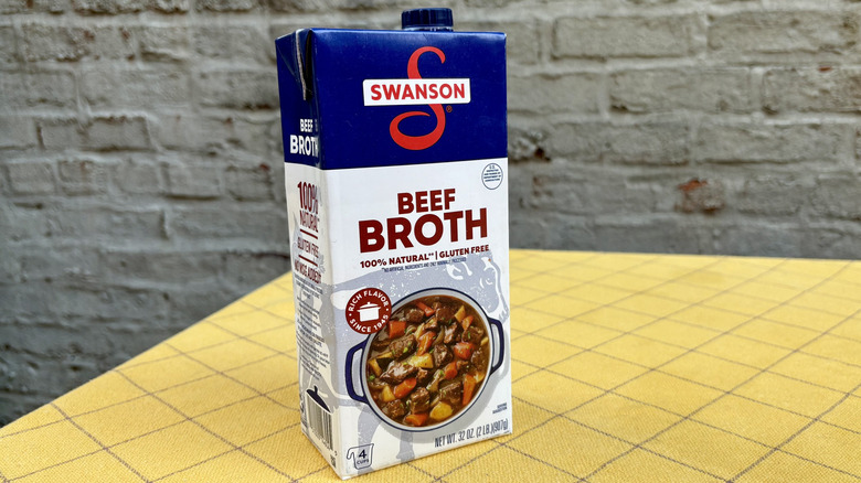 Swanson beef broth carton on a yellow tablecloth