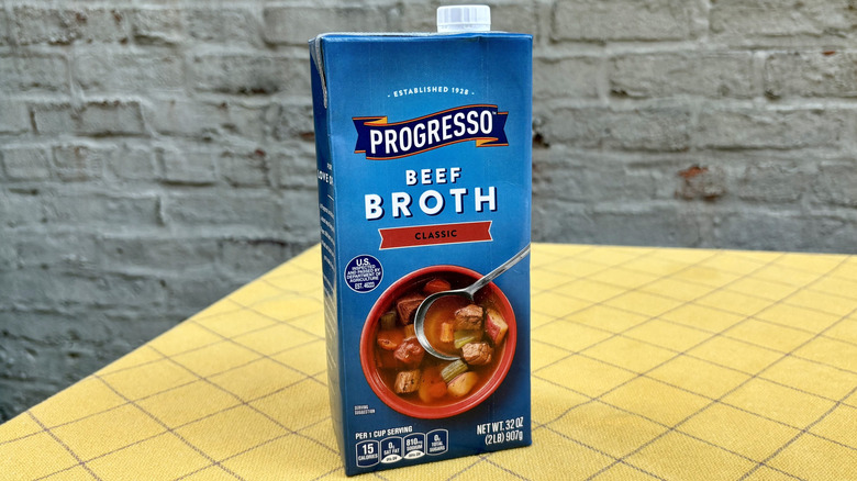 Progresso beef broth carton on yellow tabecloth