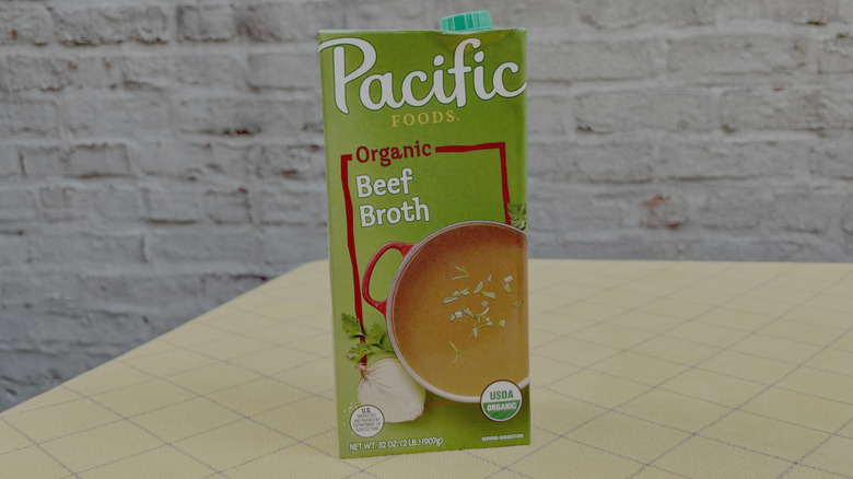 Pacific Foods beef broth carton on yellow tablecloth