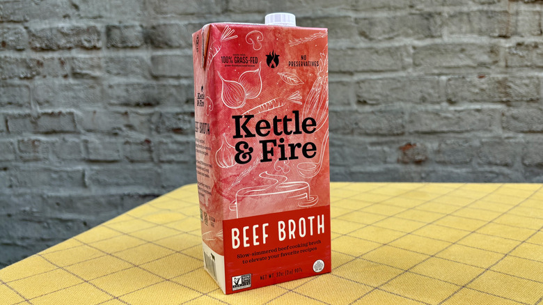 Kettle & Fire beef broth carton on a yellow tablecloth