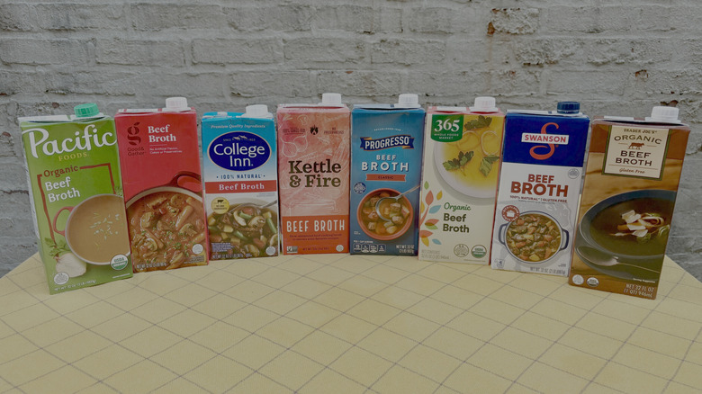 Cartons of beef broth on yellow tablecloth