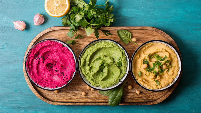 three bowls of hummus 