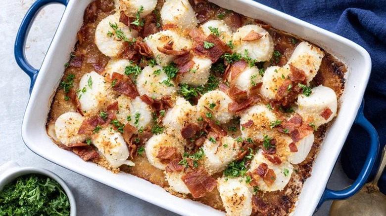 Top-down view of bacon baked scallops in a dish