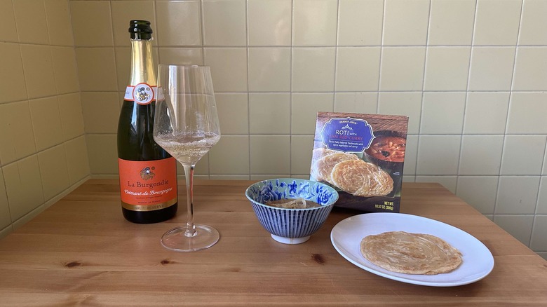 Sparkling wine and roti with curry