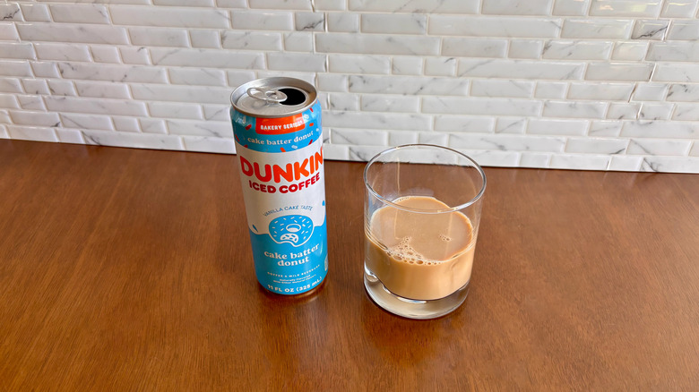 Dunkin' canned coffee next to coffee in glass