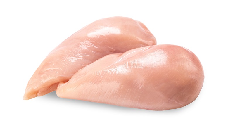 Raw chicken breast against white