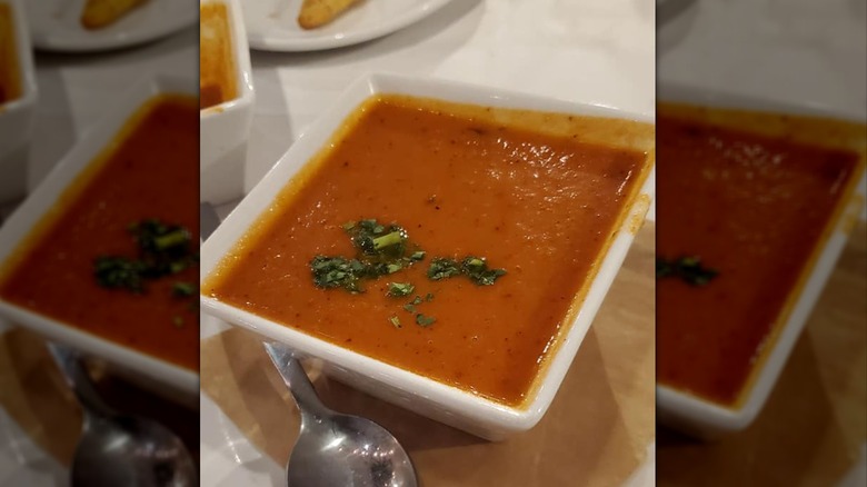 Bowl of tomato basil soup with parsley on top