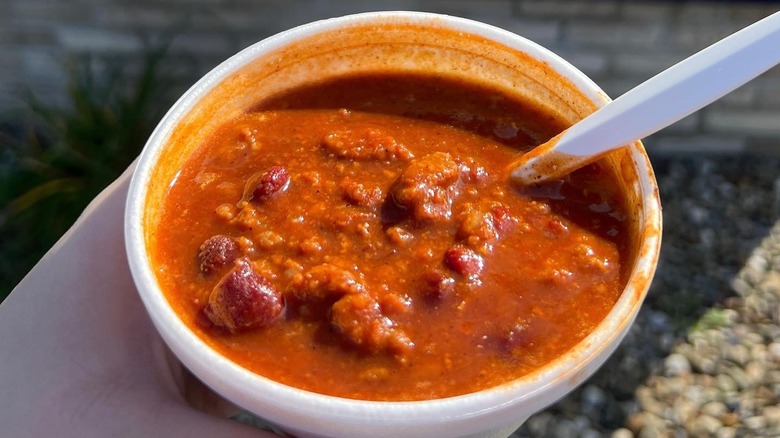 Person holding cup of chili