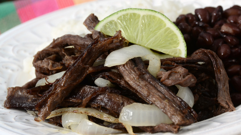 Cuban shredded beef dish topped with a lime