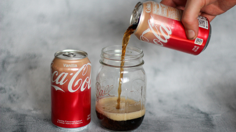 Pouring vanilla Coca-Cola can into a Mason jar