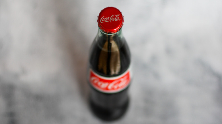 Overhead shot of a Coca-Cola cap on a glass bottle