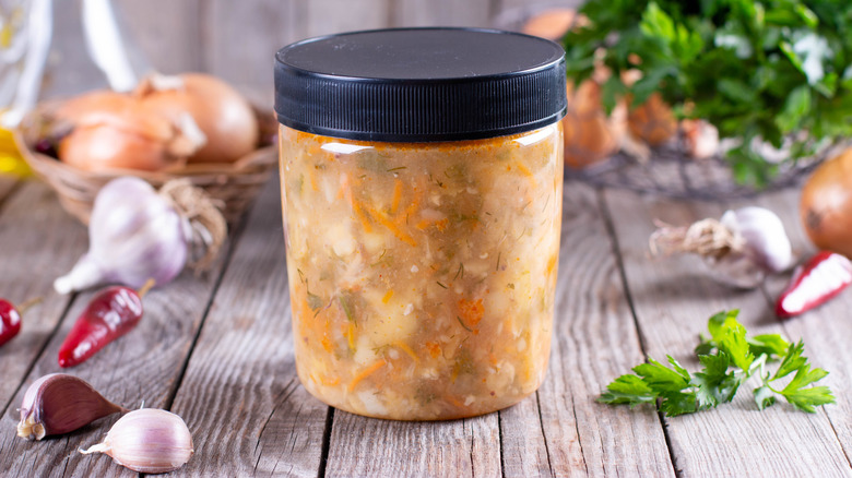 jar of frozen soup on cutting board