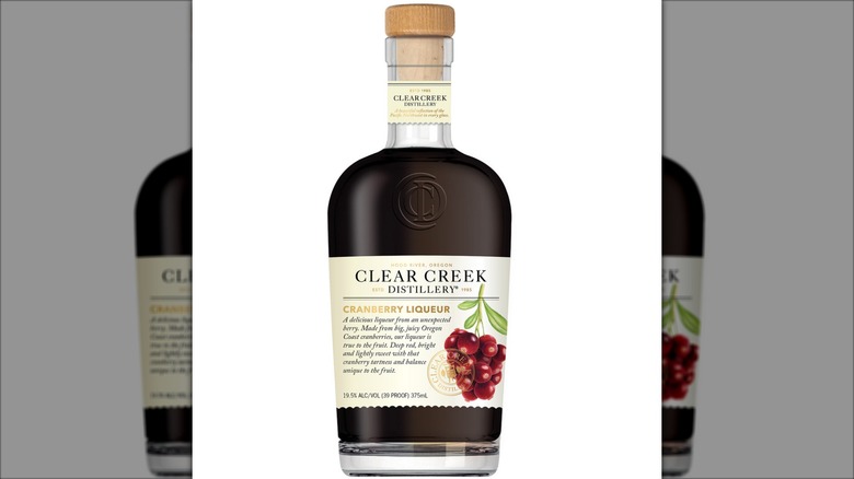 Bottle of deep red Clear Creek cranberry liqueur.