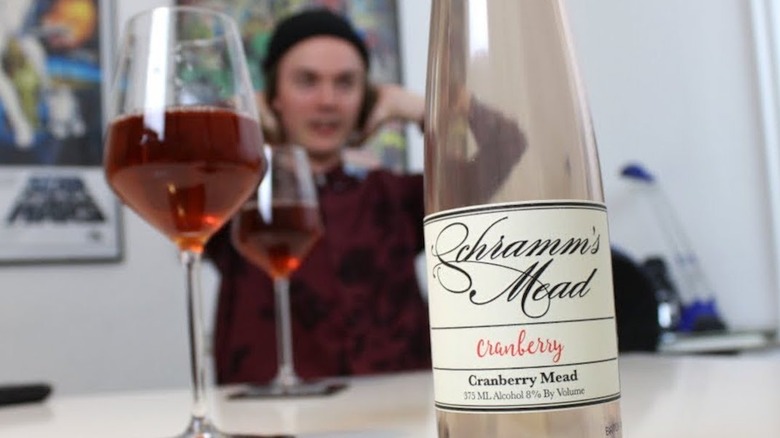 Empty bottle and poured glasses of Schramm's cranberry mead.