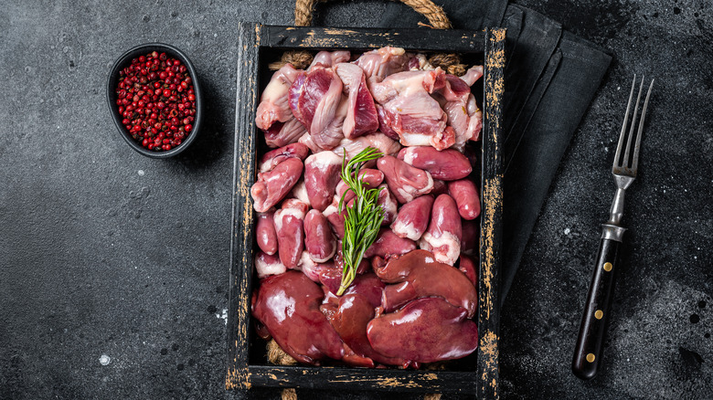 Raw turkey giblets black background