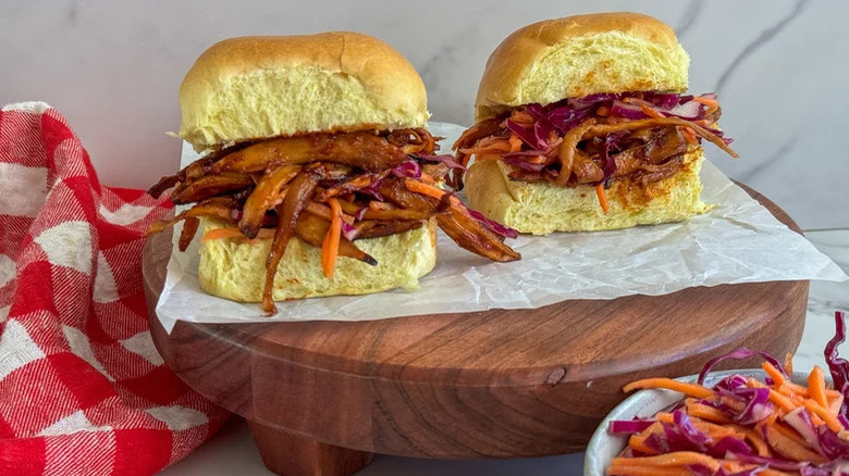 Two mushroom sliders on a wooden board 