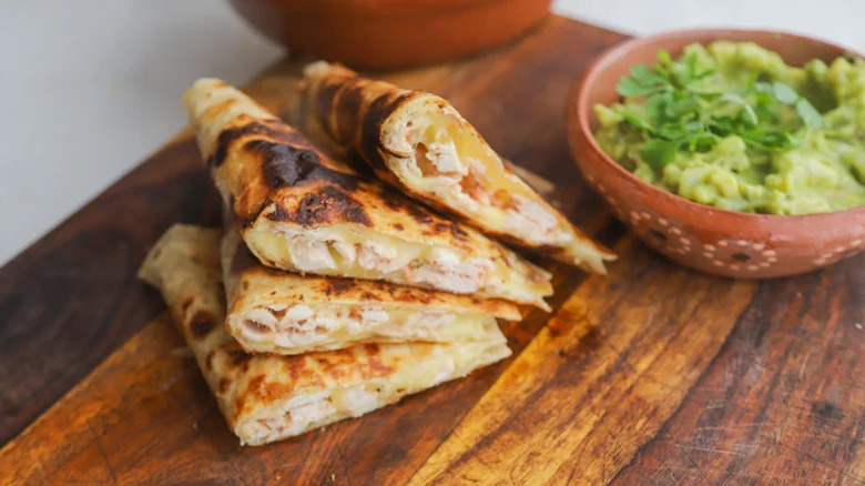 four chicken quesadilla slices stacked