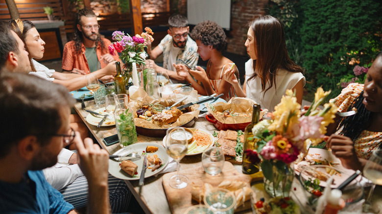 friends gathered around a table sharing a meal