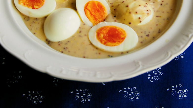 Boiled eggs in a creamy mustard sauce.