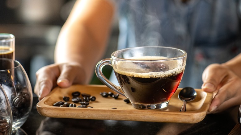 Person holding coffee cup