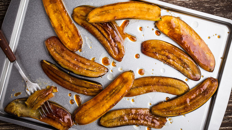 Roasted banana halves on tray