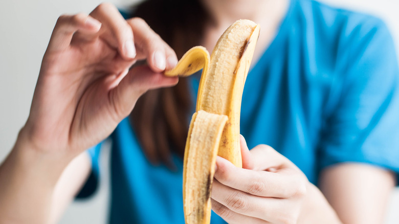 Woman peeling a banana