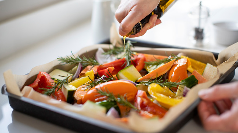 pouring oil on vegetables