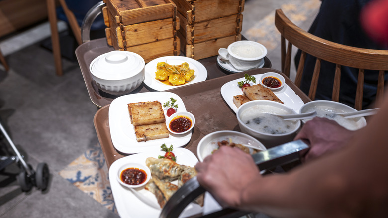 A cart of dim sum being pushed