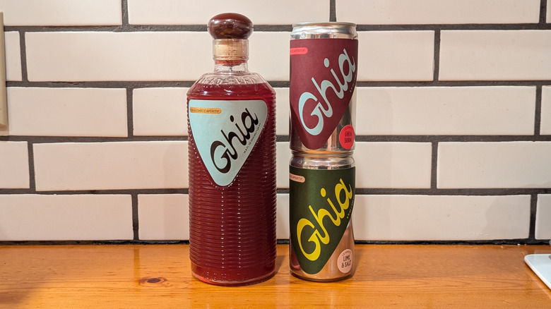 tall ribbed bottle with red NA spritz and two small cans stacked