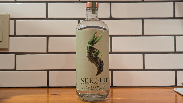 a bottle of clear botanical distilled NA spirit with a green rabbit label