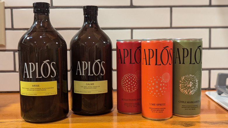 two bottled concentrate aperitifs and three colorful canned drinks