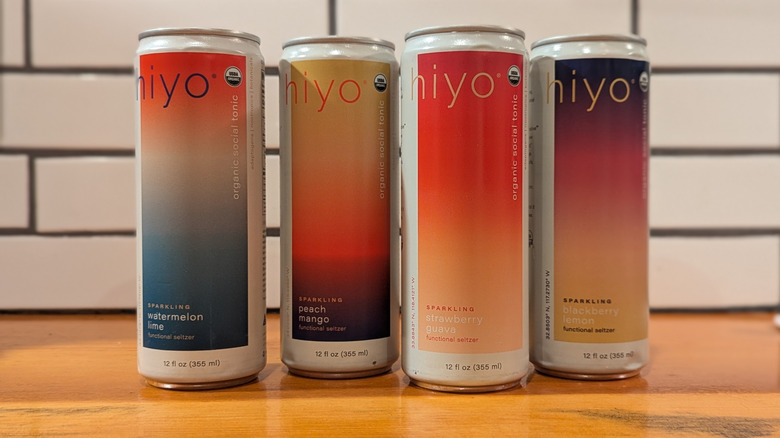 four colorful canned non-alcoholic aperitif beverages