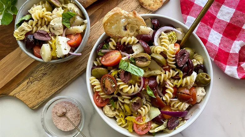 Veggie antipasti pasta salad in two white bowls