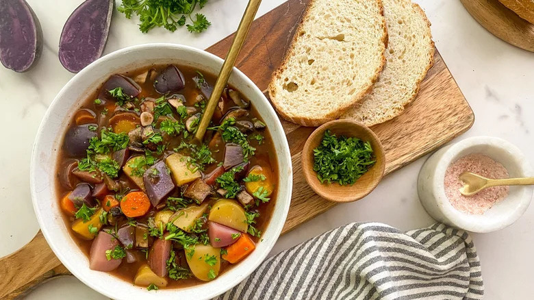 Bowl of portobello pot roast next to bread