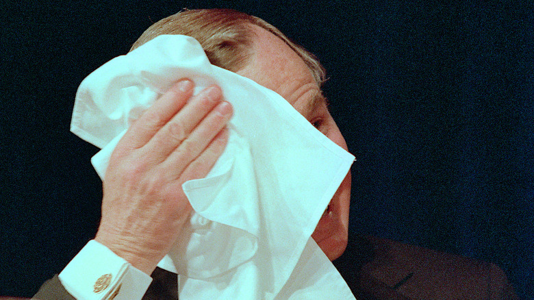 President Bush wiping his face